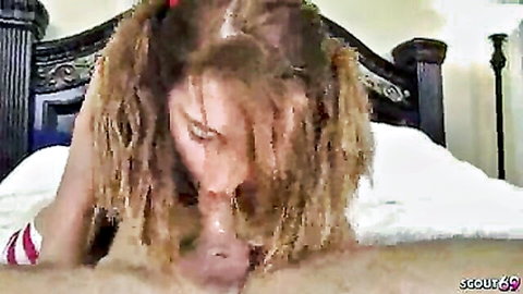 Petite freckled blonde in pigtails sucks older man's cock and balls on bed