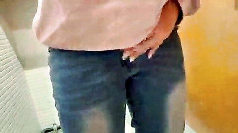 Japanese girl in pink top masturbating in jeans in public bathroom