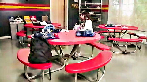 Cute Asian schoolgirl in white top and skirt at table, teasing all-girl orgy