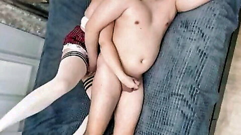 Japanese girl in plaid skirt and stockings stroking man's cock