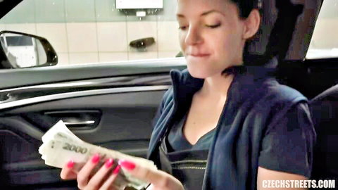 Brunette Anne counting cash in car at service station, seductive smile