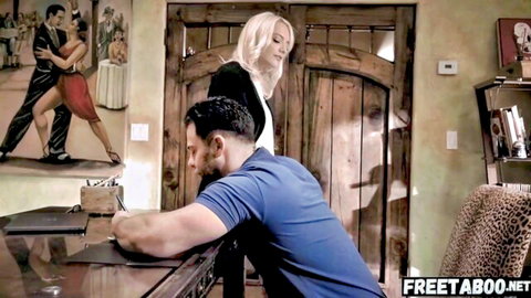 Blonde seductress in tight clothes stands behind coworker at office desk in taboo tease