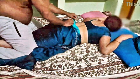 Chubby Indian man with pants down fucking saree-clad woman's exposed ass from behind on bed