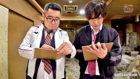 JAV doctor in white coat with student in dark jacket, intense corridor stare