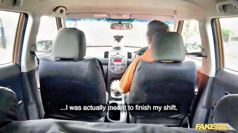 Posh cheating wife with big boobs in driving lesson car, hand on gear shift