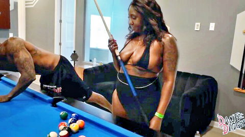 Ebony babe in skimpy blue thong bikini bent over pool table with muscular black stud behind her