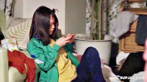 Amamiya Kanan in casual green jacket and yellow top, sitting with legs apart, JAV thumbnail