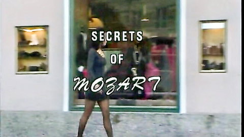 Vintage 1992 porn scene: woman in stockings and miniskirt walks by store window in Secrets of Mozart