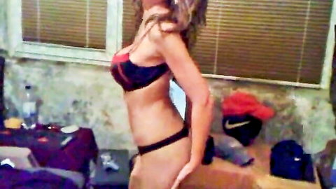 Curvy brunette girlfriend teases in red black pushup bra and thong showing huge tits and round ass side view