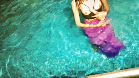 Hotty Disha as seductive mermaid in pool, black bikini top and purple tail tease