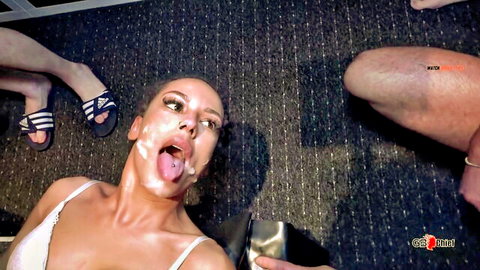 Brunette woman with facial cumshot and cum on tongue in gangbang scene