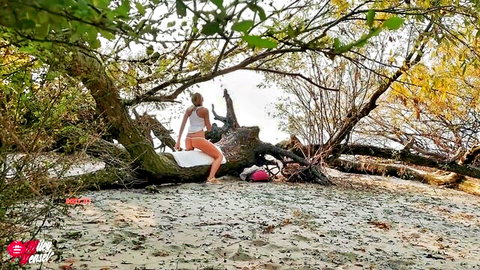Miley Weasel teases outdoors in white top and shorts on tree stump