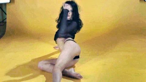 Brunette in sheer black top and thong squats spreading ass and cameltoe pussy teasing