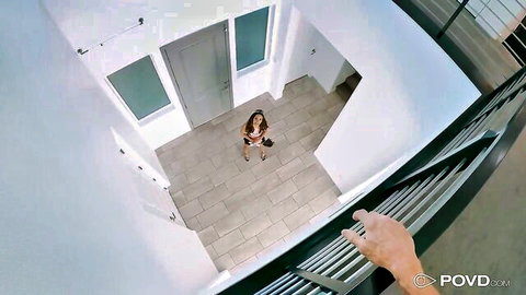 POV of skinny tanned Latina teen in skimpy orange bikini posing in modern atrium