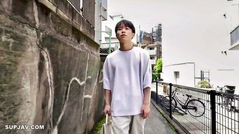 Slim Japanese man in casual white t-shirt and pants on urban alley street, mey d960 JAV thumbnail