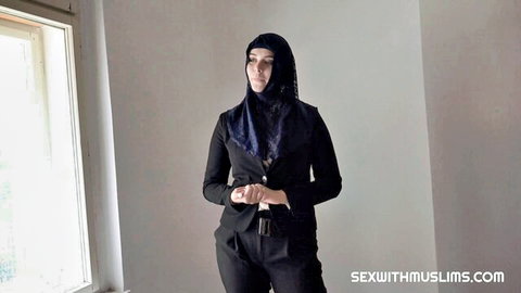 Nikky Dream in hijab and black suit posing seductively