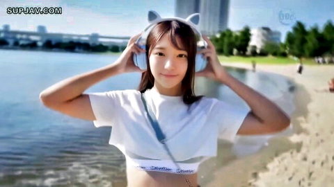 Cute Asian college influencer in cat ear headphones and crop top at beach, AV debut