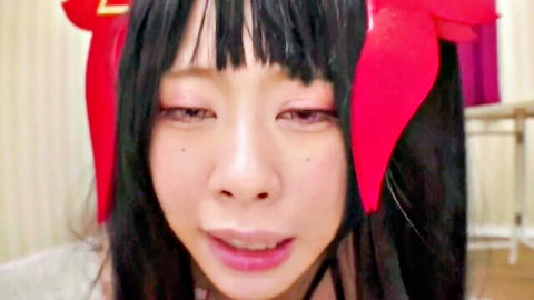 Seductive Asian cosplay girl with black twintails and red ribbons, sultry expression