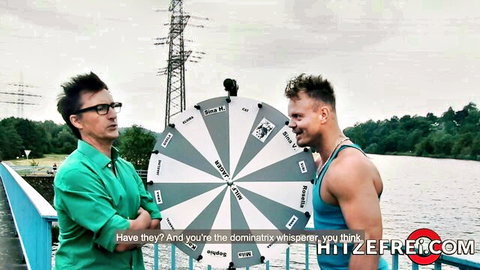 Two men in outdoor game show spinning wheel at Hitzefrei.com