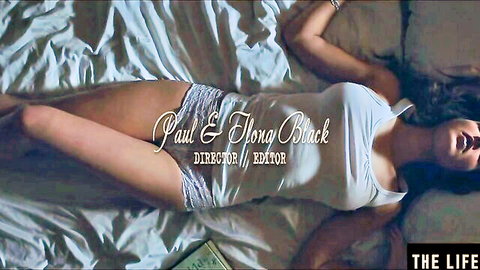 Emily J in white tank top and lace shorts, seductive pose on bed