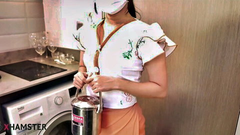 Cute Asian housekeeper Mya Mya in embroidered blouse and skirt holding pitcher