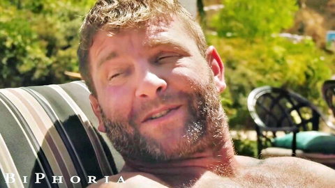 BiPhoria bearded muscular man lounging poolside in bi threesome preview