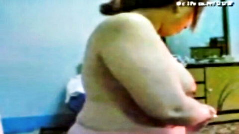 Curvy Asian MILF milking her large breasts rear view