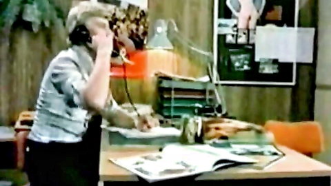 Vintage blonde woman in intimate interview on phone, office tease