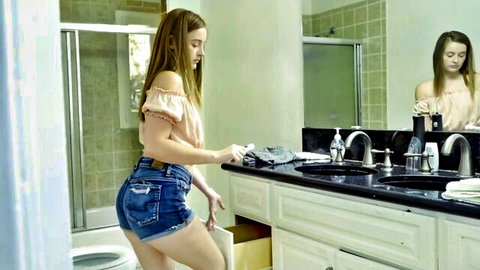 Danni Rivers bending over in short denim shorts, bathroom tease