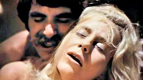 Vintage 1974 porn: Blonde woman in ecstasy embraced by mustached man