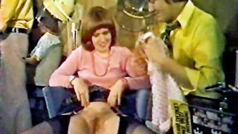 Retro 70s brunette in pink sweater with legs spread, exposed crotch in erotic shaving scene