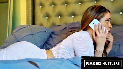 Curvy tanned Latina brunette in tight white bodysuit shows big ass on bed while talking on phone