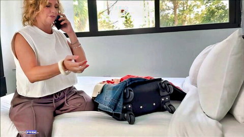 Brianna Beach packing for work trip on phone call