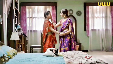 Two Indian women in colorful sarees embrace intimately in a steamy lesbian scene