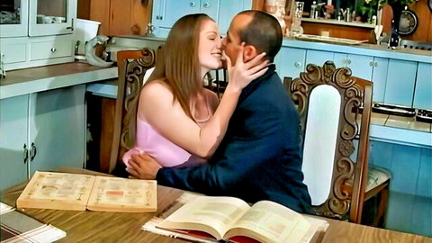Brigette Aime passionately kissing suited man in pink top