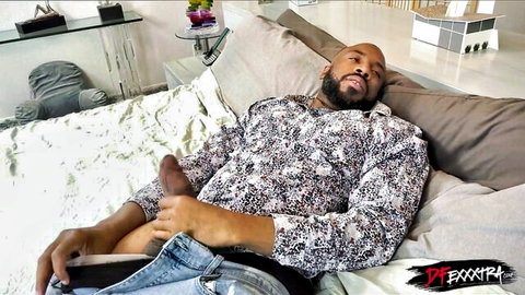 Muscular black man Mr. Jordan with massive cock exposed in bed