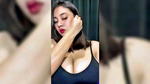 Indonesian beauty with curvy body and big cleavage in black top