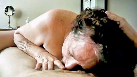 Curly-haired wrinkled mature woman giving passionate blowjob