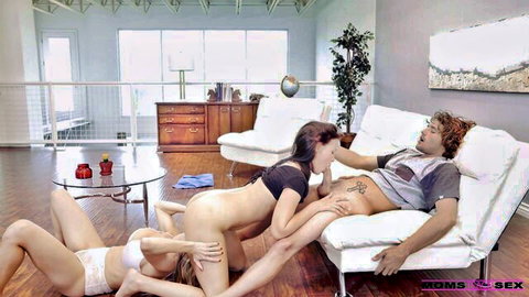 Three petite brunettes with small tits nude grope and kiss curly-haired guy on sofa in group sex