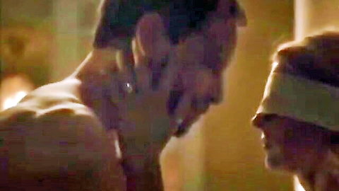 Blindfolded woman in seductive embrace with muscular shirtless man, intimate tension
