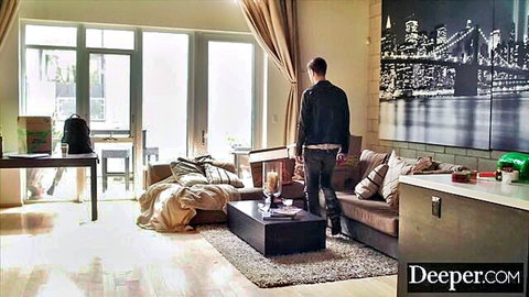 Athletic man in leather jacket stands in modern NYC apartment living room ready for action