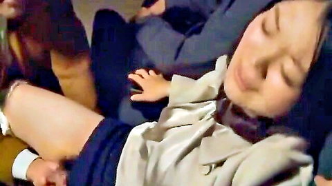 Asian woman in skirt teased by hand in dark cinema