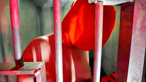 Nude woman in red hood behind bars in chastity prison scene
