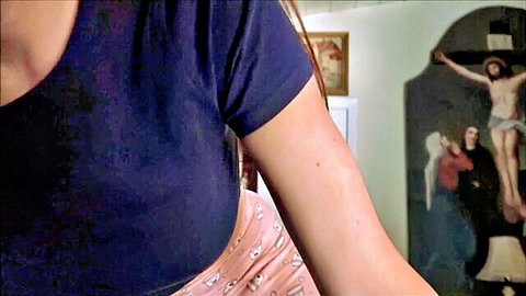 Brunette in tight blue top and pink panties showing big ass near Jesus crucifix