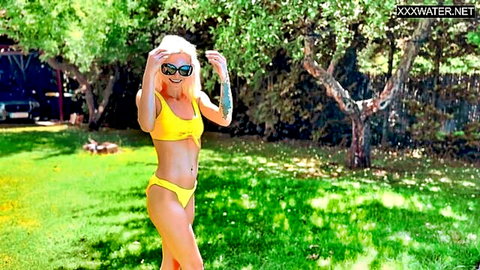 Blonde Zazie Skymm in yellow bikini posing seductively outdoors