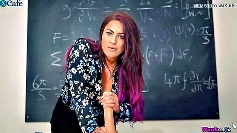 Roxy R as seductive teacher in Sex Education, purple hair, deep cleavage pose