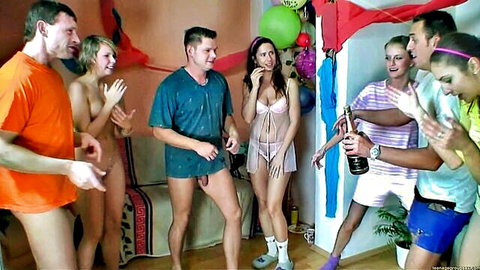 Group of lingerie-clad and nude women partying with topless men, popping champagne at sex party start