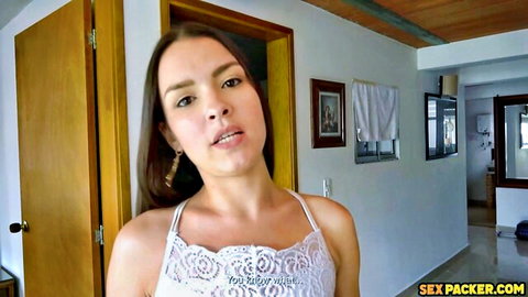 Brunette Latina in sheer lace camisole top teasing with cleavage in bedroom doorway