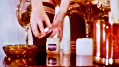 Vintage hands lighting candle in classic XXX scene from Smokey and the Bare Lady