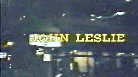 John Leslie vintage porn title screen in glowing yellow text on dark background